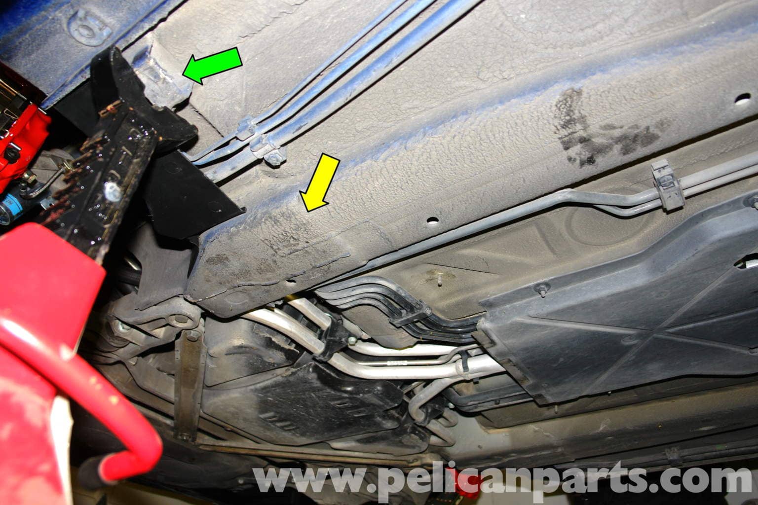 Figure 1: Reinforced area of the front chassis (yellow arrow) — the best point to place the floor jack. The standard factory jack support areas (green arrow) are where jack stands go.