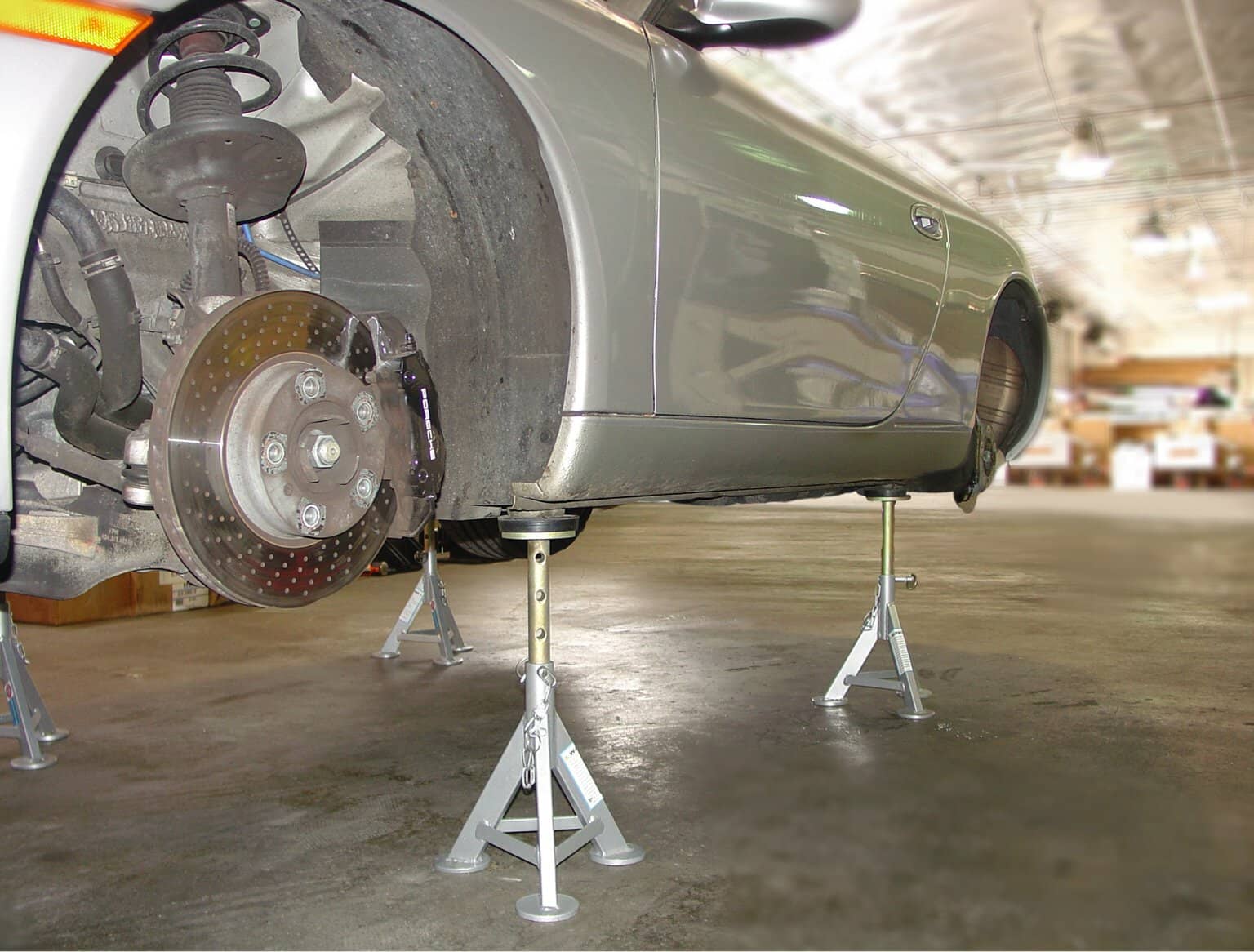 Figure 3: The best place to support the 911 Carrera with jack stands is under the factory jack support areas. These four spots on either side of the car have metal cup pieces that act as locators for professional-style hydraulic lifts.