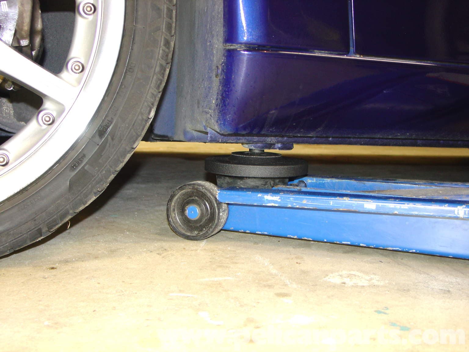Figure 4: A jack plate tool attaches to the points under the car and gives you a nice, wide circular surface to use with your floor jack for better stability and ease.